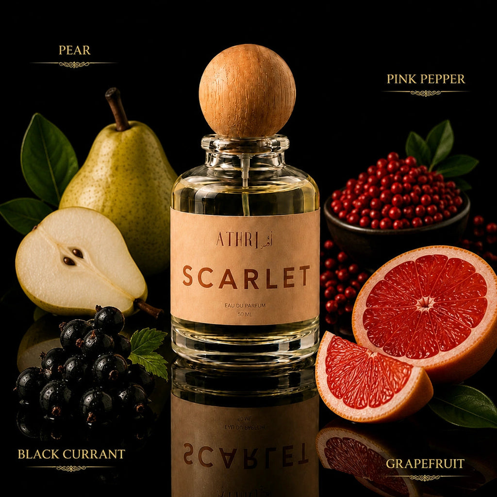 A perfume bottle labeled 'A1M3 SCARLET' centered on a black reflective surface, surrounded by fruit and berries representing the scent notes: pear, pink pepper, black currant, and grapefruit. The bottle has a round wooden cap and a beige label.