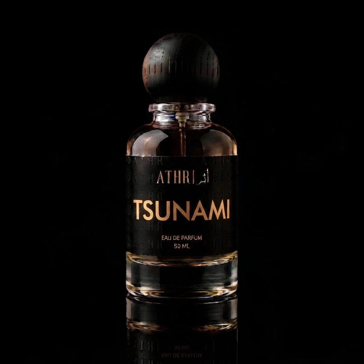 A 50 ml bottle of Athiri Tsunami Eau de Parfum with a black label and a dark wooden cap, set against a solid black background with a subtle reflection below.