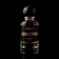 A 50 ml bottle of Athiri addiction Eau de Parfum with a black label and a dark wooden cap, set against a solid black background with a subtle reflection below.