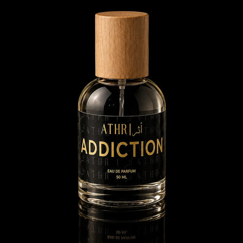 Perfume bottle labeled 'Addiction' by Athra on a black background