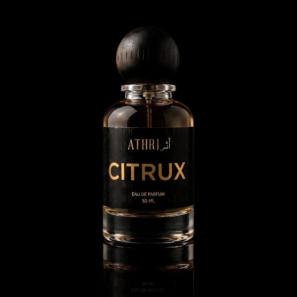 A 50 ml bottle of Athri Citrux Eau de Parfum with a black label and a dark wooden spherical cap, set against a solid black background with a subtle reflection below.