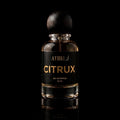 A 50 ml bottle of Athri Citrux Eau de Parfum with a black label and a dark wooden spherical cap, set against a solid black background with a subtle reflection below.