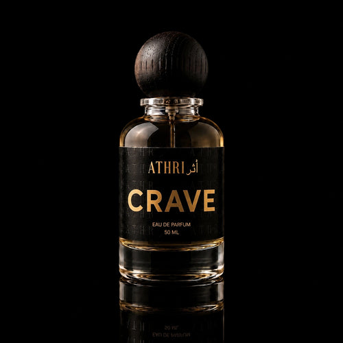 A 50 ml bottle of Athri Crave Eau de Parfum with a black label and a dark wooden spherical cap, set against a solid black background with a subtle reflection below.