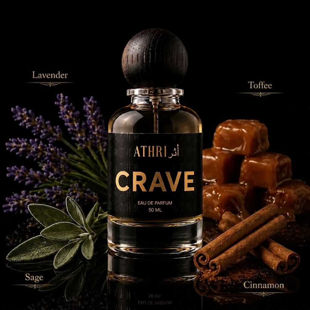 A 50 ml bottle of ATHRI CRAVE Eau de Parfum with a dark wooden cap, set against a black background and surrounded by its scent notes: lavender, toffee, sage, and cinnamon.