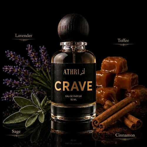 A 50 ml bottle of ATHRI CRAVE Eau de Parfum with a dark wooden cap, set against a black background and surrounded by its scent notes: lavender, toffee, sage, and cinnamon.