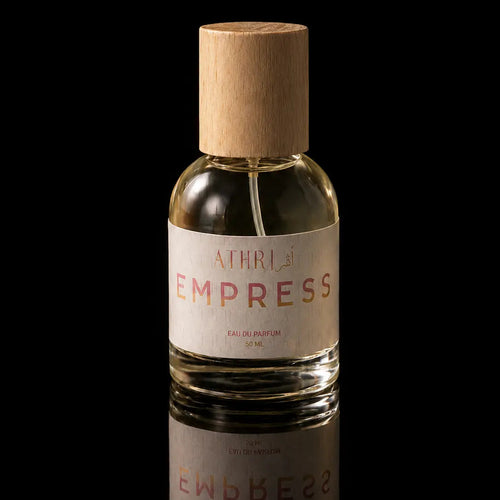Bottle of Athir Empress perfume with a cork cap on a black background