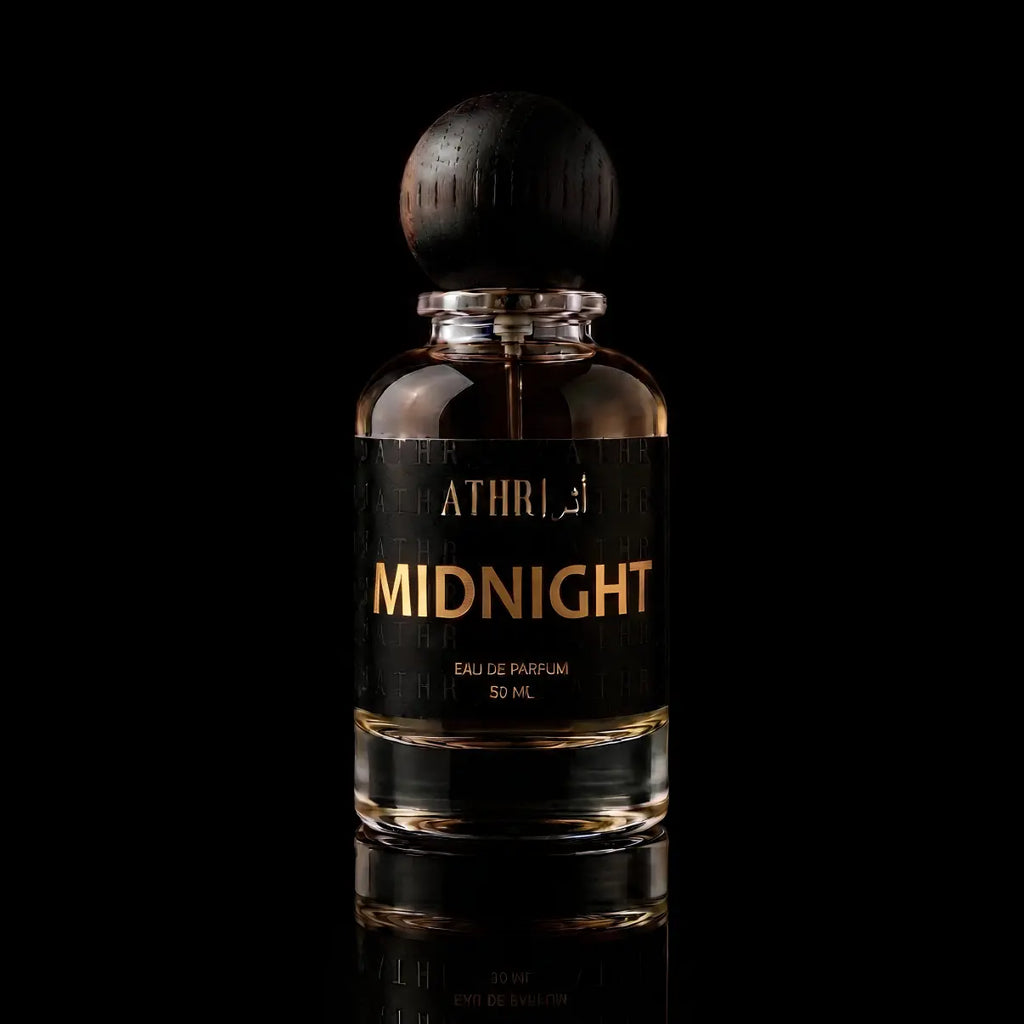 A 50 ml bottle of Athiri Midnight Eau de Parfum with a black label and a dark wooden cap, set against a solid black background with a subtle reflection below.