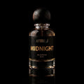 A 50 ml bottle of Athiri Midnight Eau de Parfum with a black label and a dark wooden cap, set against a solid black background with a subtle reflection below.