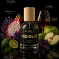 Athr Midnight eau de parfum bottle with fruits, flowers, and a glass of cognac on a dark background.
