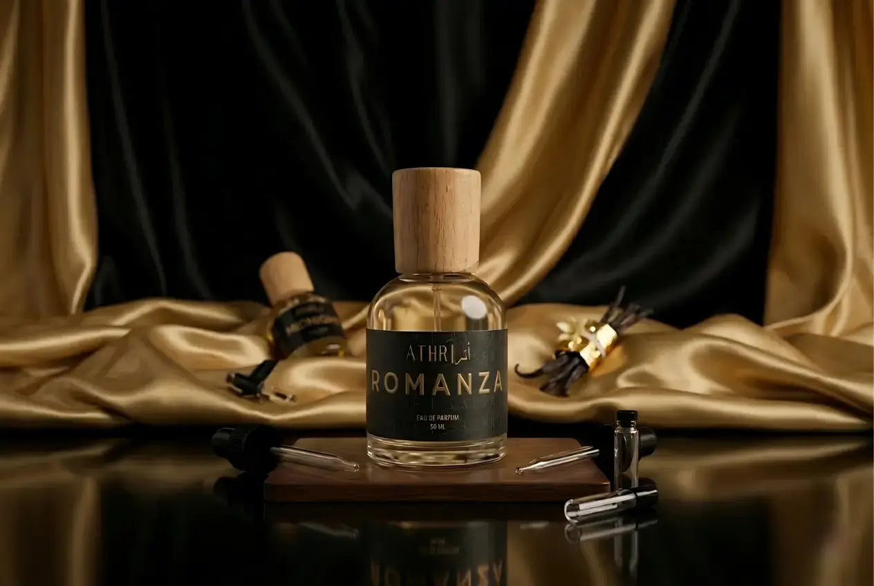 Perfume bottle labeled 'Afrirram Pomelza' on a wooden tray with gold and black draped fabric in the background.