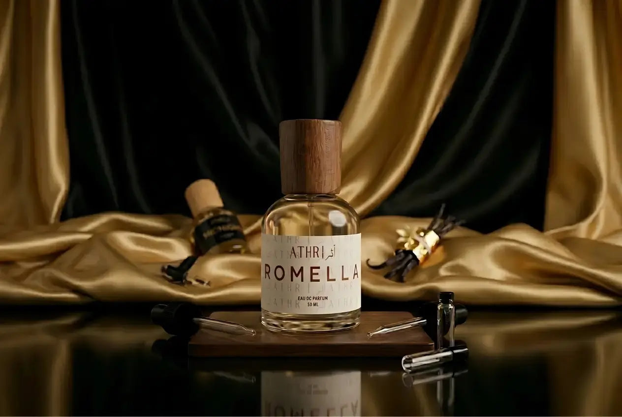 Perfume bottle labeled 'Romella' on a wooden board with gold fabric background