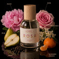 Athri Rosa perfume bottle with flowers and fruits on a black background